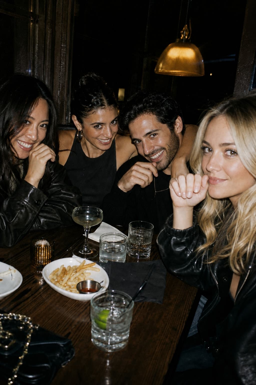 Friends sharing a booth late at night