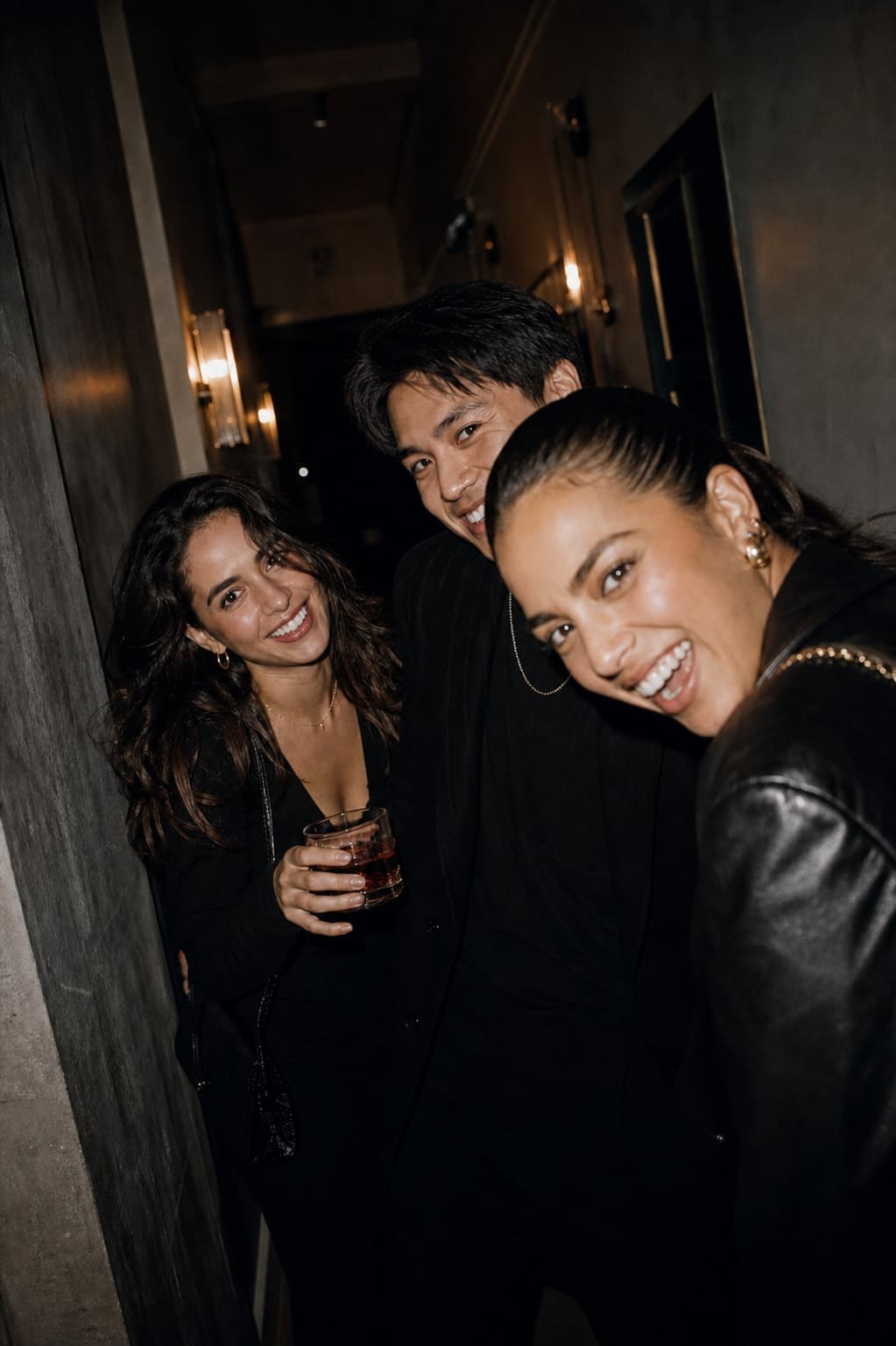 Friends heading down a hallway after midnight